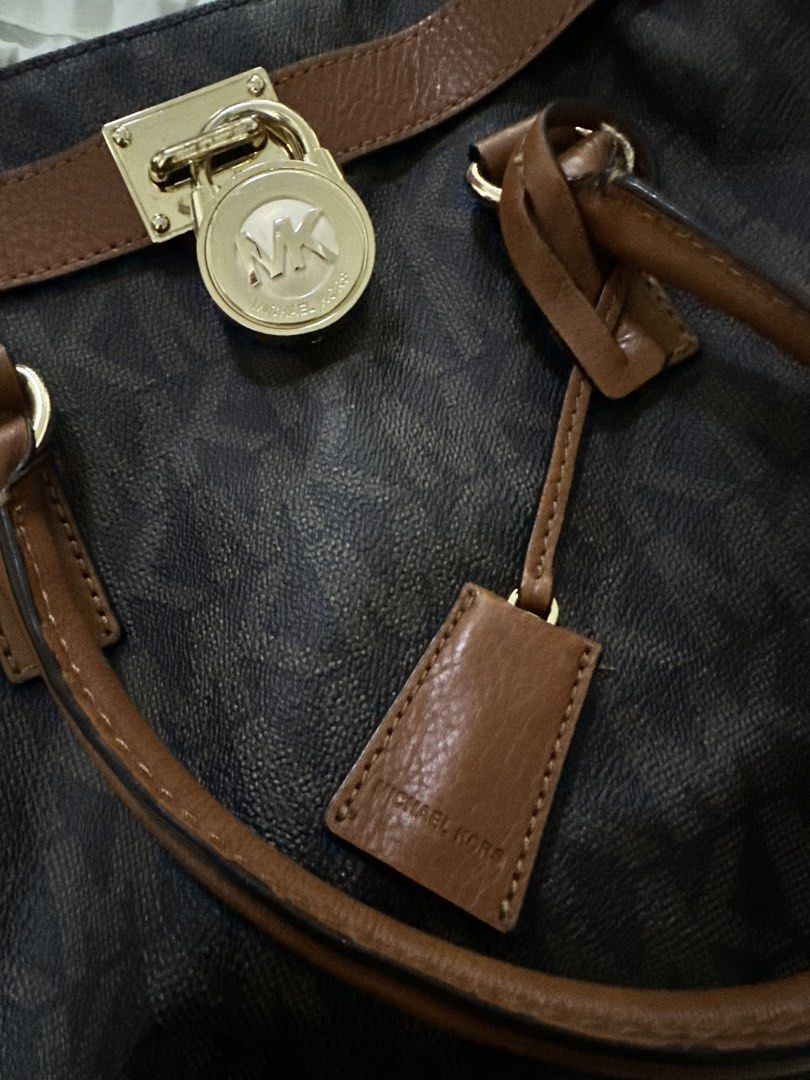 Michael Kors Handbag with Dust Bag (Category: Luxury Bags & Wallets) located in Bulacan. Submitted by mommysuki (Listing ID 1432395541, Image 2). Description: - Authentic Michael Kors handbag - Brown monogram pattern - Tan leather accents - Gold-tone chain strap - Includes dust bag - Multiple interior compartments - Secure lock closure with MK logo - Ideal for everyday use.