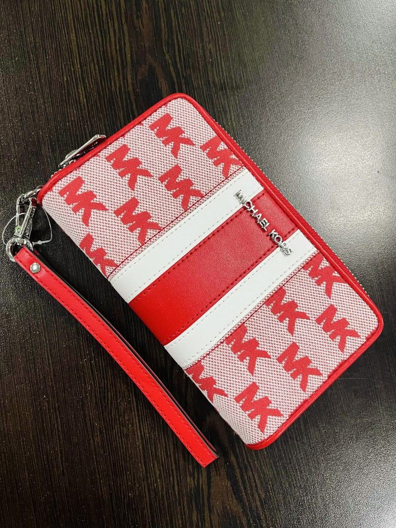 Michael Kors Red MK Print Wallet (Category: Wallets & Card holders) located in Pasig City. Submitted by stuffsnme (Listing ID 1432548516, Image 1). Description: - Michael Kors wallet with a striking red and white MK print. - Secure zip-around closure. - Convenient wrist strap for easy carrying. - Interior with multiple card slots and compartments for organization. - Features a stylish red leather stripe with the Michael Kors logo. - Includes the 