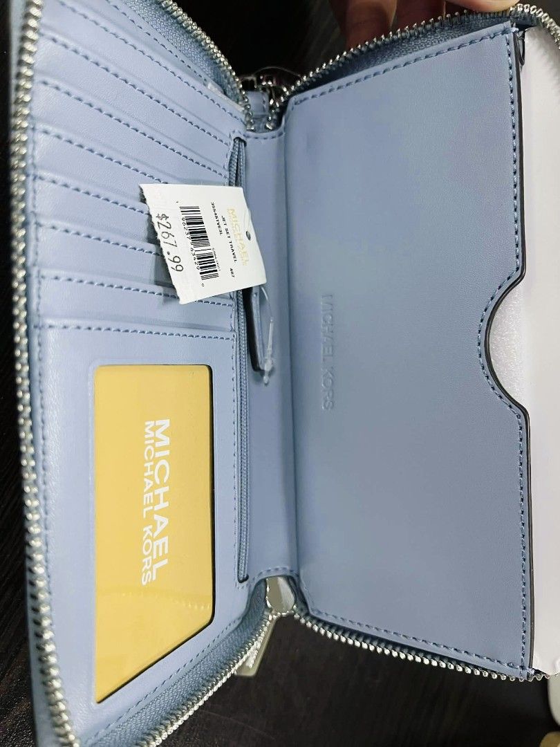 Michael Kors Wristlet Wallet (Category: Luxury Bags & Wallets) located in Pasig City. Submitted by stuffsnme (Listing ID 1432548739, Image 2). Description: - Michael Kors wristlet wallet - Light blue color - Zip-around closure - Includes wrist strap - Multiple card slots - Compartment for cash or phone - Original price tag attached.