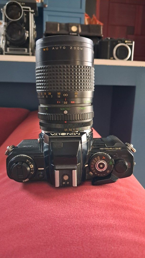 Minolta X-700 Camera with Zoom Lens (Category: Cameras) located in Santa Rosa. Submitted by majanice (Listing ID 1432463110, Image 2). Description: - Minolta X-700 SLR camera - Black camera body - Includes zoom lens - Lens features focal length markings - Lens has focus ring and aperture settings - Top dial for camera settings condition untested not guaranteed to be working.