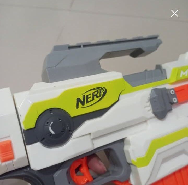 Nerf Modulus Toy Gun (Category: Action & Battle Toys) located in Manila. Submitted by kb_kg (Listing ID 1432585414, Image 3). Description: - Nerf Modulus toy gun - Color scheme: White, gray, orange, and yellow - Battery Operated - Comes with scope and other attachments - Nerf logo visible - "Modulus" text visible as is where is.