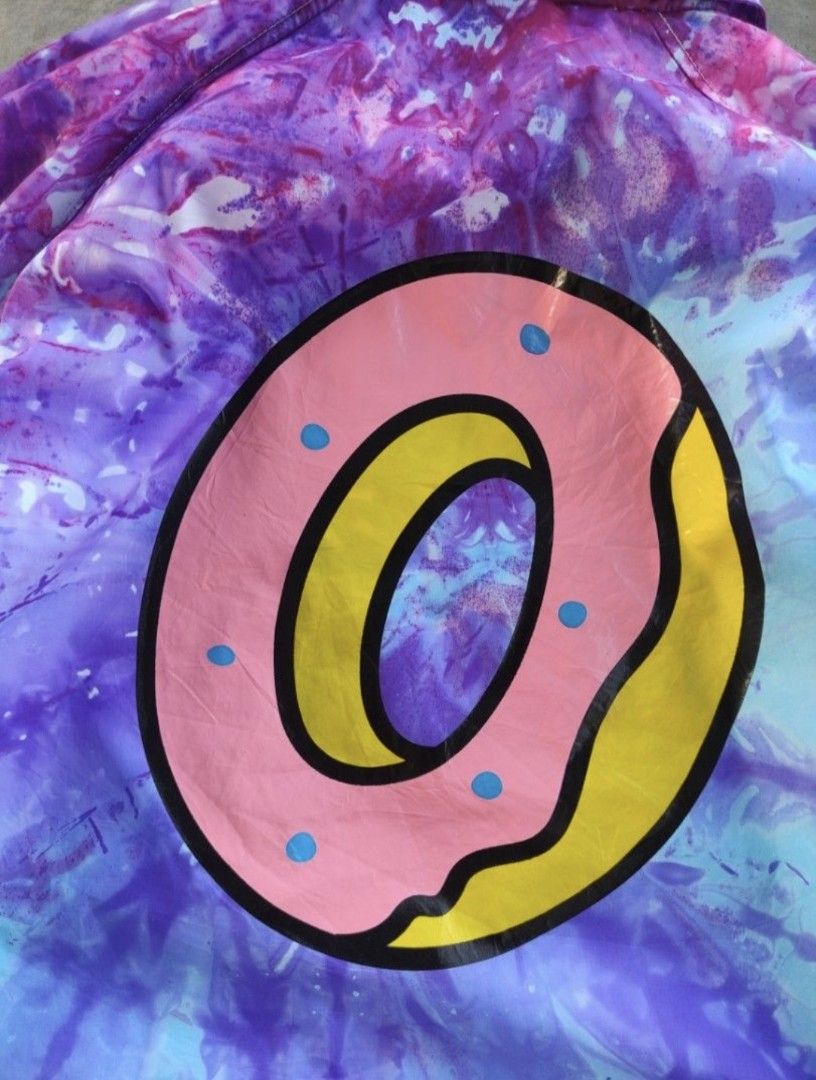 Odd Future Tie Dye Jacket (Category: Coats, Jackets and Outerwear) located in Pasig City. Submitted by khaid (Listing ID 1432527871, Image 3). Description: - Odd Future coach jacket - Tie-dye design (purple, blue, pink) - Size: xl - xxl - Features donut graphic on back - "Odd Future" logo on front - Material: Nylon - Drawstring at bottom - Button closures.