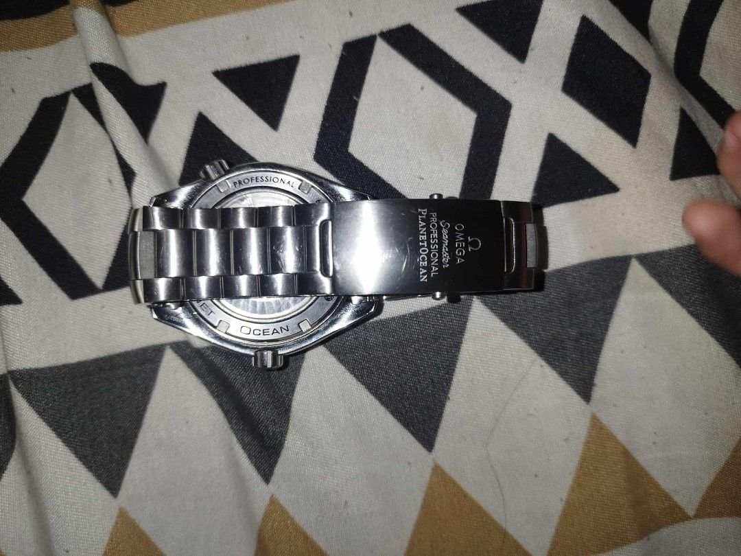 Omega Seamaster Planet Ocean Watch (Category: Luxury Watches) located in Manila. Submitted by epicwind_1bf746 (Listing ID 1432568984, Image 3). Description: - Omega Seamaster Planet Ocean watch - Silver dial with striking orange accents - Durable stainless steel bracelet - Sleek black bezel - Convenient date display at the 3 o'clock position - Features a visible movement - Secure clasp with Omega logo and Planet Ocean text.