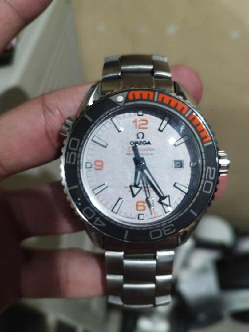 Omega Seamaster Planet Ocean Watch (Category: Luxury Watches) located in Manila. Submitted by epicwind_1bf746 (Listing ID 1432568984, Image 1). Description: - Omega Seamaster Planet Ocean watch - Silver dial with striking orange accents - Durable stainless steel bracelet - Sleek black bezel - Convenient date display at the 3 o'clock position - Features a visible movement - Secure clasp with Omega logo and Planet Ocean text.