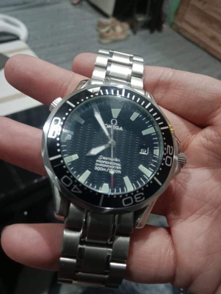 Omega Seamaster Professional 300m Watch (Category: Luxury Watches) located in Manila. Submitted by epicwind_1bf746 (Listing ID 1432578968, Image 2). Description: - Omega Seamaster Professional - Black dial - Stainless steel bracelet - Date display at 3 o'clock - Unidirectional rotating bezel - Omega Seamaster logo on case back - Omega logo on clasp.