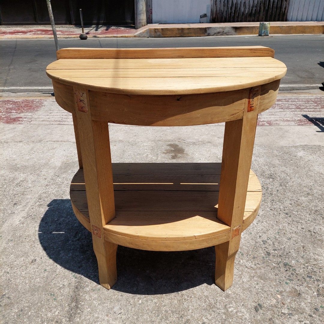 Rustic Half-moon Console Table (Category: Tables & Sets) located in Makati City. Submitted by tahanan (Listing ID 1432418712, Image 1). Description: For Sale.. A rustic wooden console table or a side table with semi-circular top and a lower storage shelf Made of Tanguile and Gmilina woods Height: 32.5 inches Width : 34.5 inches Depth : 23.5 inches.