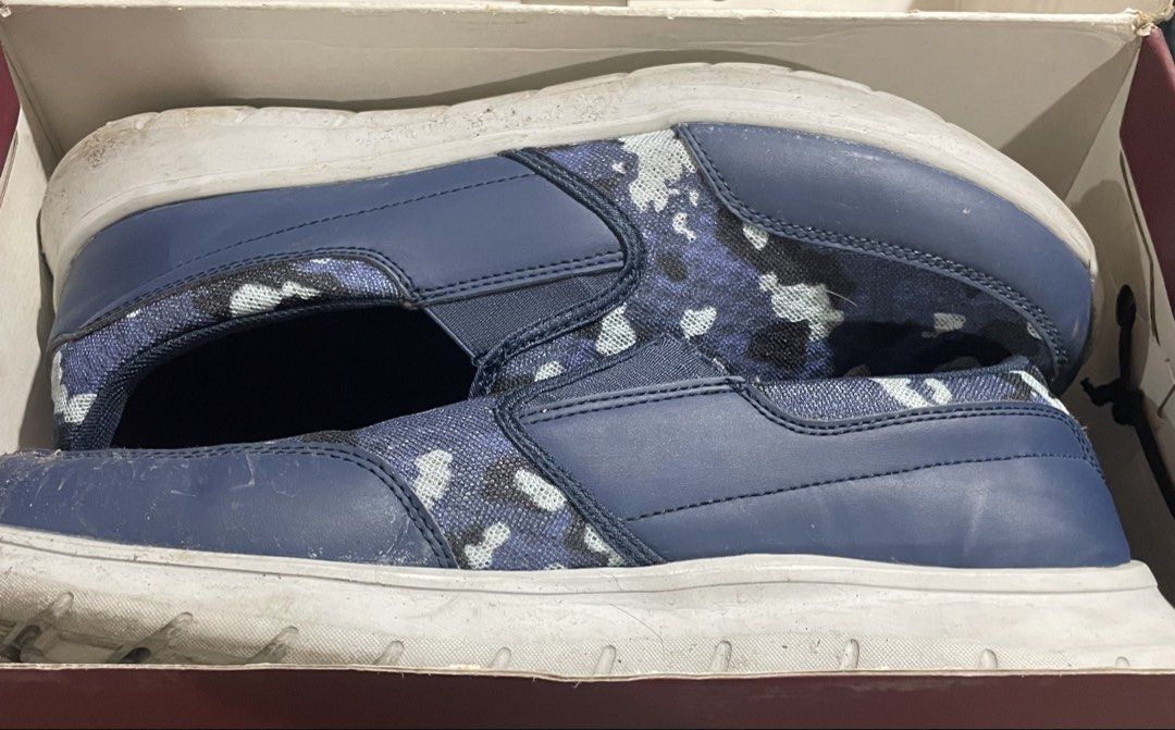 Slip-on Sneakers Blue Camo (Category: Casual Shoes) located in Caloocan City. Submitted by jetcon (Listing ID 1432559326, Image 1). Description: - Blue slip-on sneakers with camo design - White sole - Blue upper with camo pattern - Shows wear on soles - Made of synthetic materials - Size 14.