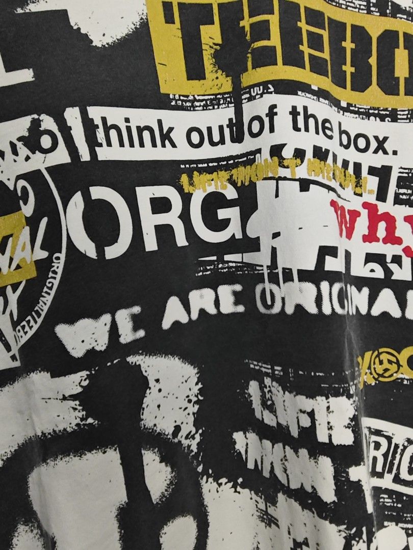 Teebox (Category: Tshirts & Polo Shirts ) located in Rizal. Submitted by itsmecle0 (Listing ID 1432446637, Image 3). Description: This shirt features an all-over "newspaper" or collage-style print with various logos and slogans, including "ORG" and "THE BOX." While it shares visual similarities with high-fashion designs like those from Louis Vuitton and Desigual, the specific garment appears to be a graphic streetwear tee often found through spec