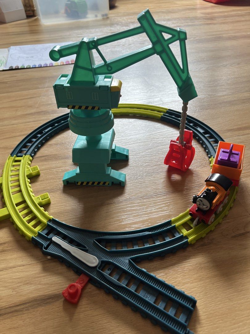 Thomas & Friends Crane Train Set (Category: Vehicle & Diecast Models) located in Quezon. Submitted by smallville.ph (Listing ID 1432441267, Image 2). Description: - ACTUAL ITEM POSTED. As is, where is Thomas & Friends train set - Includes Nia the train - Features a cargo car with purple cargo - Includes a crane for lifting and moving cargo - Comes with a track layout - Train is orange and black with the number 18.