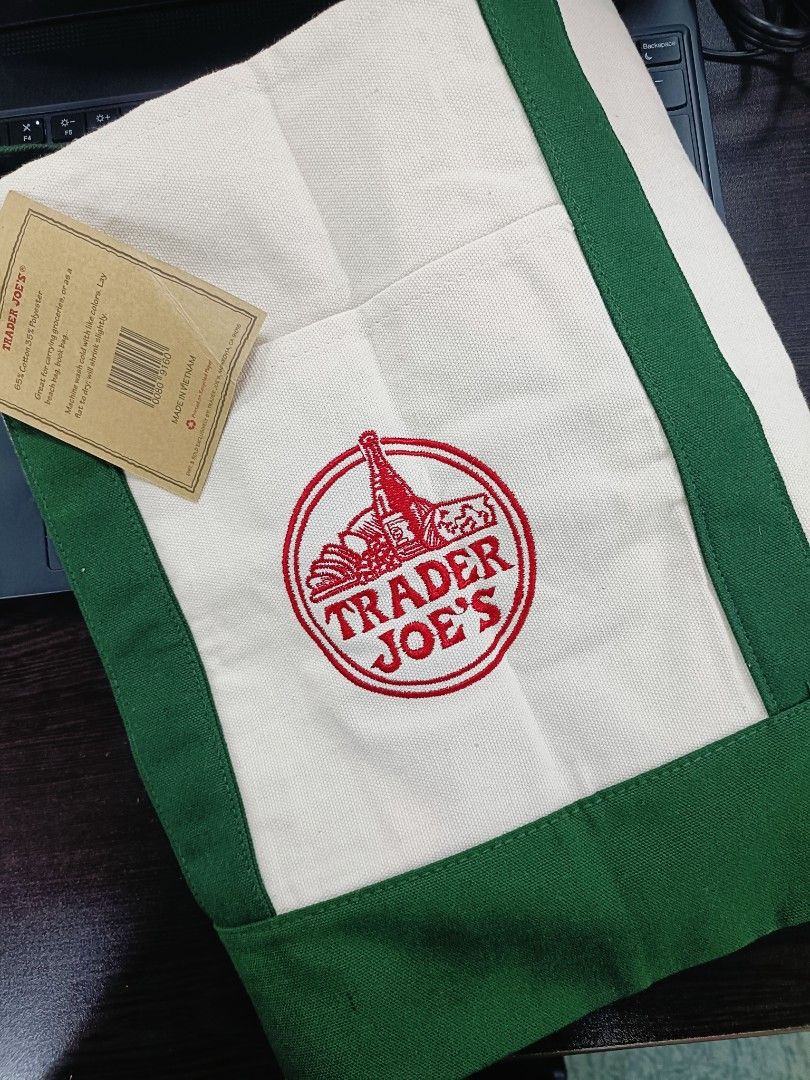 Trader Joe's Canvas Tote Bag (Category: Tote Bags) located in Pasig City. Submitted by stuffsnme (Listing ID 1432546023, Image 1). Description: - Authentic Trader Joe's tote bag - White canvas body - Green trim - Features Trader Joe's logo - Includes tag - Perfect for groceries or everyday use - Durable and stylish.