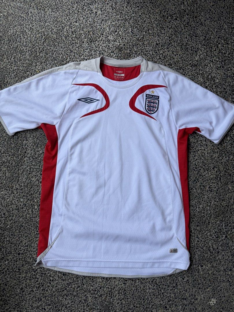 Umbro England National Team Jersey (Category: Tshirts & Polo Shirts ) located in Dinalupihan. Submitted by thrift.trips (Listing ID 1432564029, Image 1). Description: - Official England Umbro jersey - Size: M - Color: White with red accents - Material: Polyester and nylon - Features: England crest, Umbro logo, X-Static tag - Length 29 - Width 20.5.