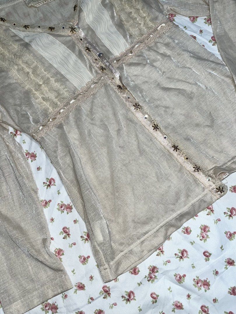 Vintage Beige Blouse with Lace Details (Category: Blouses) located in Pasay City. Submitted by prettiest_girl_in_the_world (Listing ID 1432437459, Image 3). Description: - Vintage beige blouse - Intricate lace and ruffle detailing - V-neckline - Long sleeves - Decorative embellishments - Semi-sheer fabric - Perfect for vintage-inspired looks.