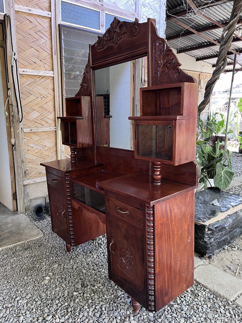 Vintage Narra Vanity Table with Mirror (Category: Tables & Sets) located in Bagabag. Submitted by arrjem (Listing ID 1432405587, Image 2). Description: - Vintage Narra vanity table with mirror - Multiple drawers and cabinets for storage - Decorative carvings and glass-fronted compartments - Rich, dark wood finish - Well-maintained condition - Width approximately 52 inches.