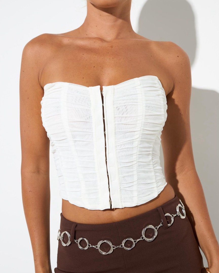 White Corset Top (Category: Sleeveless) located in Manila. Submitted by inationg (Listing ID 1432591345, Image 1). Description: - White strapless corset top - Features ruched fabric - Hook-and-eye closure - Fitted silhouette - Made of lightweight material - Ideal for high-waisted bottoms.