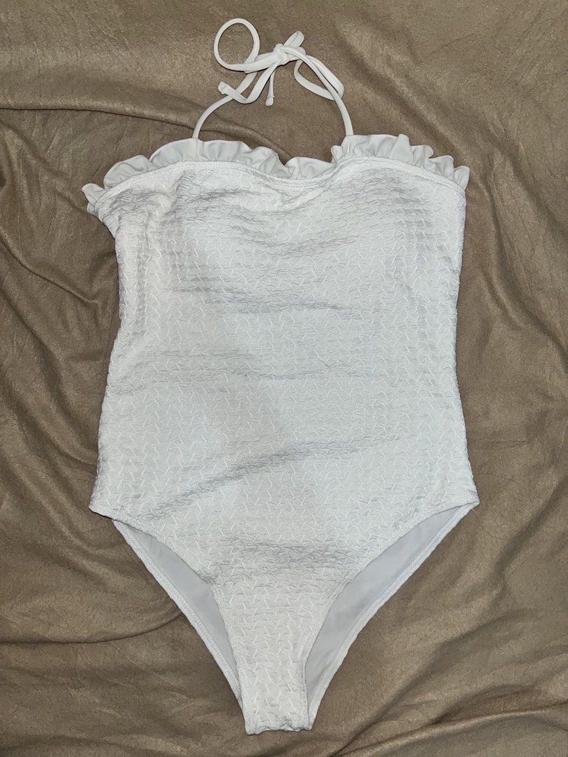 White Ruffle One-Piece Swimsuit (Category: Bikinis & Swimsuits) located in Manila. Submitted by quarishop21 (Listing ID 1432510186, Image 3). Description: (Used Once only) - White one-piece swimsuit - Features ruffle detailing - Textured fabric - Halter neck tie (can be worn strapless) - Ideal for beach or pool days.