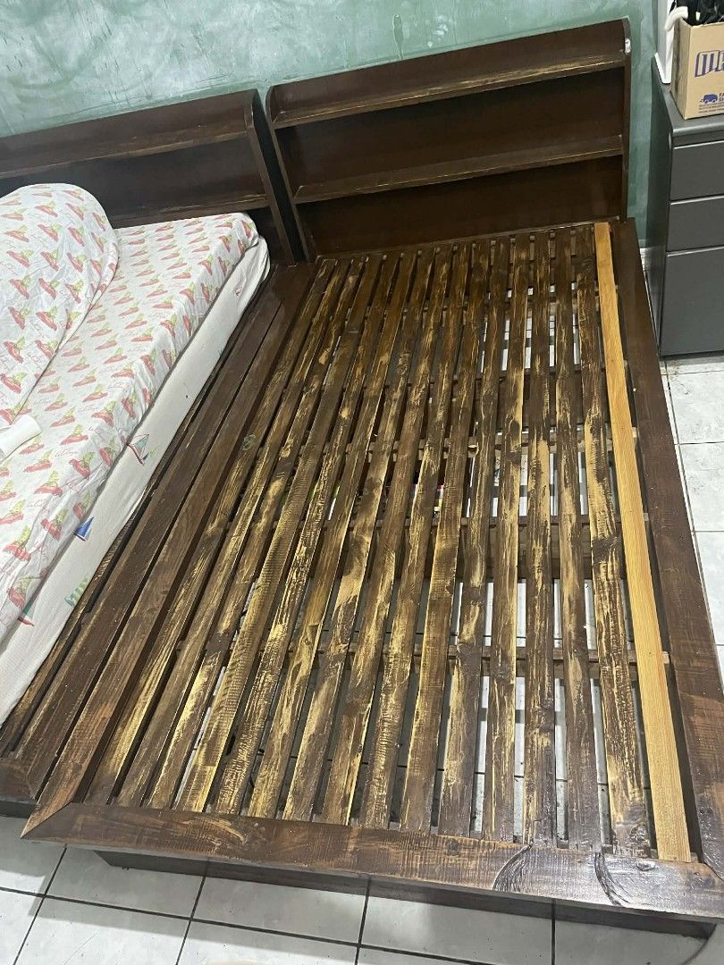 Wooden Bed Frame with Headboard (Category: Bed Frames & Mattresses) located in Muntinlupa City. Submitted by relovemycloset (Listing ID 1432540762, Image 2). Description: - Wooden bed frame - Includes headboard with shelf - Slatted base - Dark brown finish 📌All solid wood single bed with headboard that can be used as storage 📌Both beds have drawer on the side 📌2 beds available 📌Size: 111 x 201 x 23 cm (WLH) from floor 77cm na ang height 📌Oth