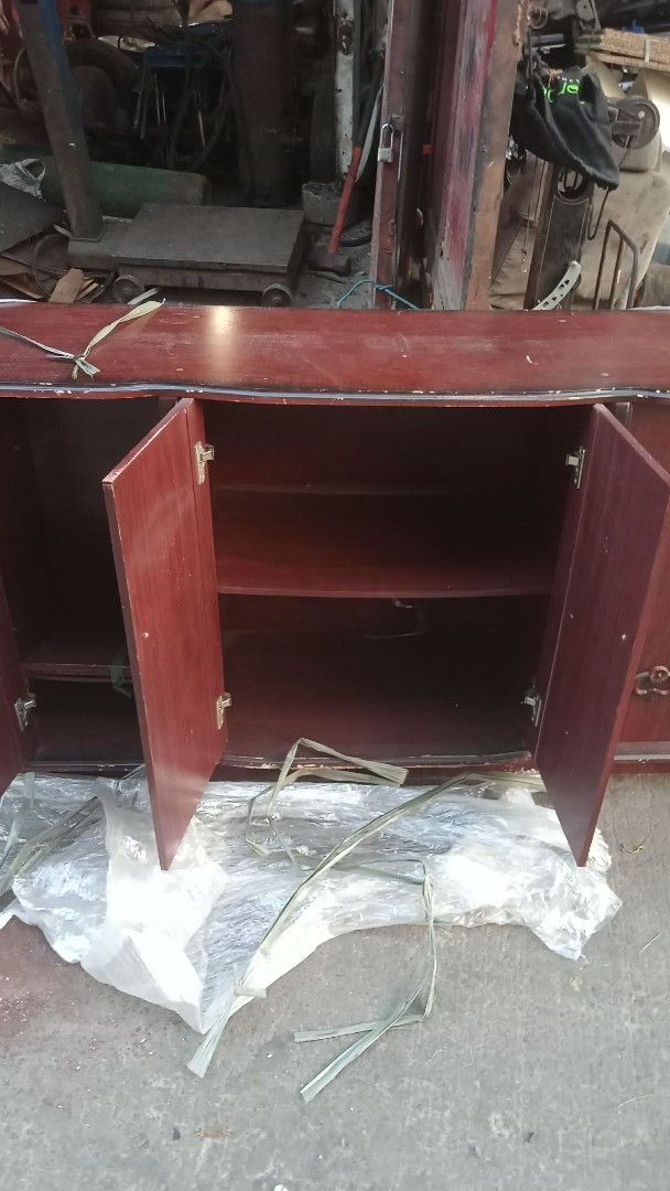 Wooden Cabinet with 4 Doors (Category: Shelves, Cabinets & Racks) located in Quezon City. Submitted by madelrivera (Listing ID 1432501319, Image 2). Description: - Wooden cabinet - Four doors - Decorative carvings - Reddish-brown finish - Multiple shelves - Ideal for storage.
