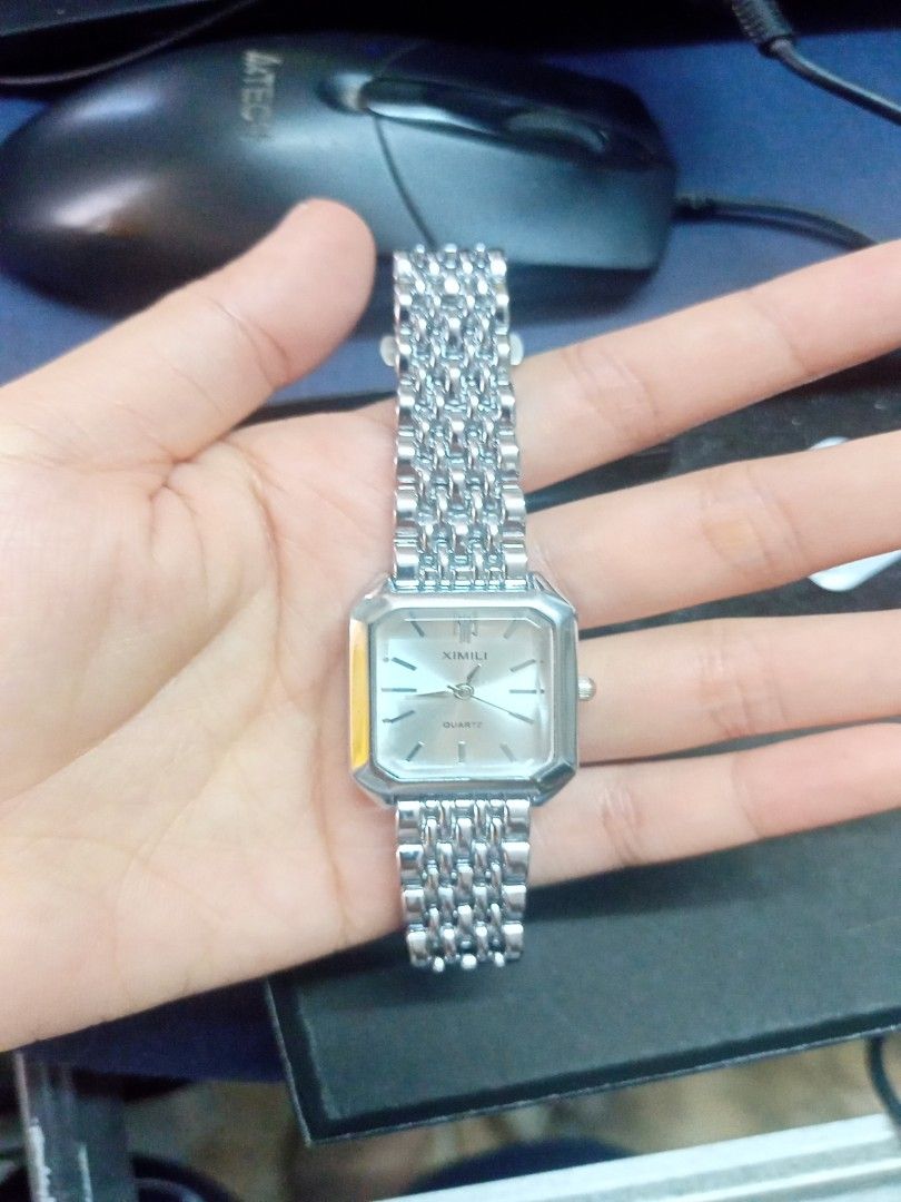 XIMIVOGUE Quartz Watch (Category: Women's Watches) located in Manila. Submitted by perro.cl (Listing ID 1432435775, Image 2). Description: - XIMILI quartz watch - Silver rectangular dial - Stainless steel bracelet - Includes original box - Comes with an extra battery - Adjustment tool included - Classic design - Suitable for everyday wear - only worn once and super good as new RFS - I have new watch.