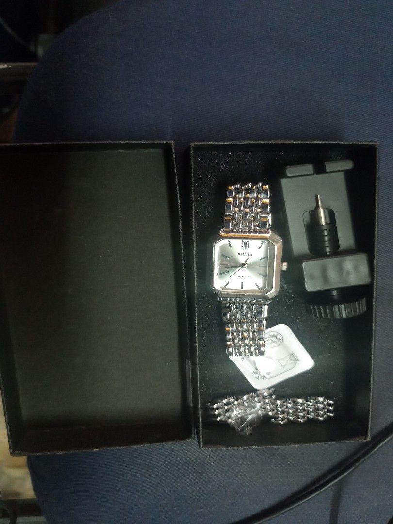 XIMIVOGUE Quartz Watch (Category: Women's Watches) located in Manila. Submitted by perro.cl (Listing ID 1432435775, Image 1). Description: - XIMILI quartz watch - Silver rectangular dial - Stainless steel bracelet - Includes original box - Comes with an extra battery - Adjustment tool included - Classic design - Suitable for everyday wear - only worn once and super good as new RFS - I have new watch.