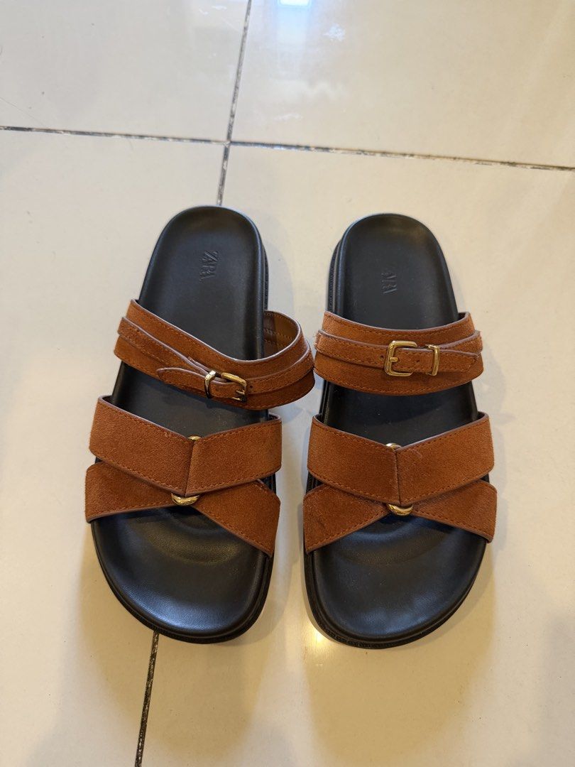 Zara Brown Suede Sandals (Category: Flats & Sandals) located in Pasig City. Submitted by CuratedProj (Listing ID 1432394078, Image 2). Description: - Zara sandals - Brown suede upper - Black sole - Adjustable buckle straps - Black footbed with Zara logo - Perfect for casual wear - Comfortable and stylish.