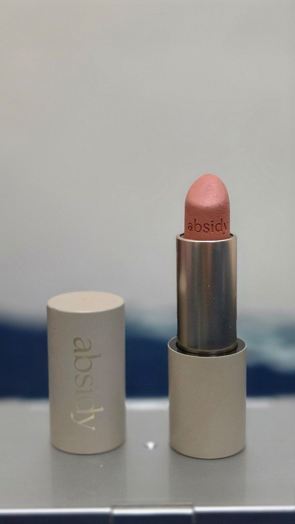 Absidy Lipstick Pink skies (Category: Makeup) located in Manila. Submitted by meredithdcsto (Listing ID 1432746589, Image 1). Description: - Brand: "Absidy" - Color: Light Pink - Packaging: Silver tube with beige cap - Features: Brand name printed on cap, lipstick partially extended.