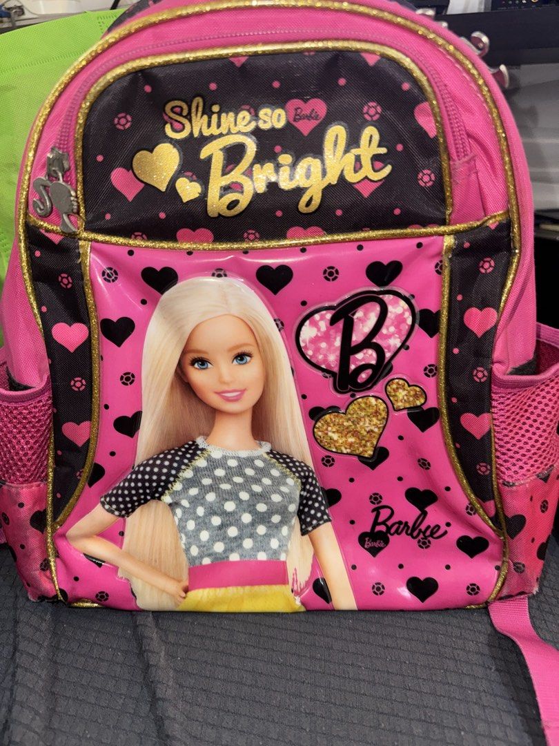 Barbie Pink Backpack (Category: Backpacks) located in Paranaque City. Submitted by ledzai (Listing ID 1432628319, Image 1). Description: - Pink Barbie backpack age 3 to 7yrs old - Features a large Barbie graphic - Includes "Shine so Bright" text - Two side pockets - Adjustable straps - Barbie-print interior lining - Dimensions: Approximately 15 inches (H) x 12 inches (W) .