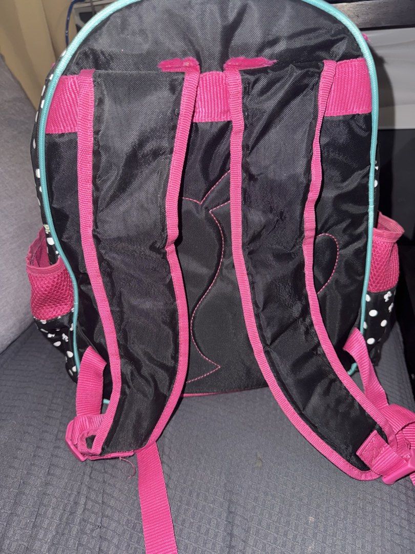 Barbie Squad Goals Backpack (Category: Babies & Kids Fashion) located in Paranaque City. Submitted by ledzai (Listing ID 1432630204, Image 3). Description: - Barbie backpack with a fun pink and black polka dot design. - Features "Barbie Squad Goals" graphics. - Multiple compartments for storage, including a front pocket and side pockets. - Pink interior. - Adjustable straps for a comfortable fit. - Adorned with Barbie logo zipper charms. - Ideal 