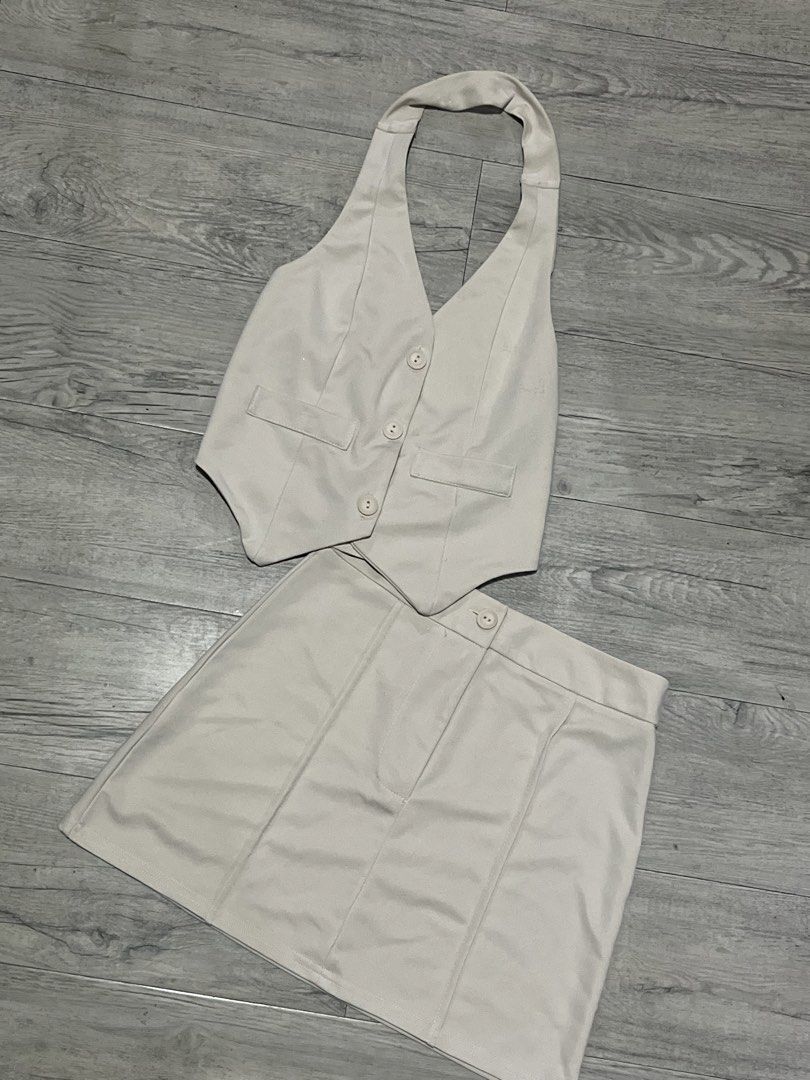 Beige Halter Vest and Mini Skirt Set (Category: Sets or Coordinates) located in Manila. Submitted by declutbyal (Listing ID 1432708434, Image 1). Description: - Beige two-piece set - Halter vest with button details - Matching mini skirt - Tailored vest fit with pockets - Classic skirt design - Perfect for casual or night-out wear.