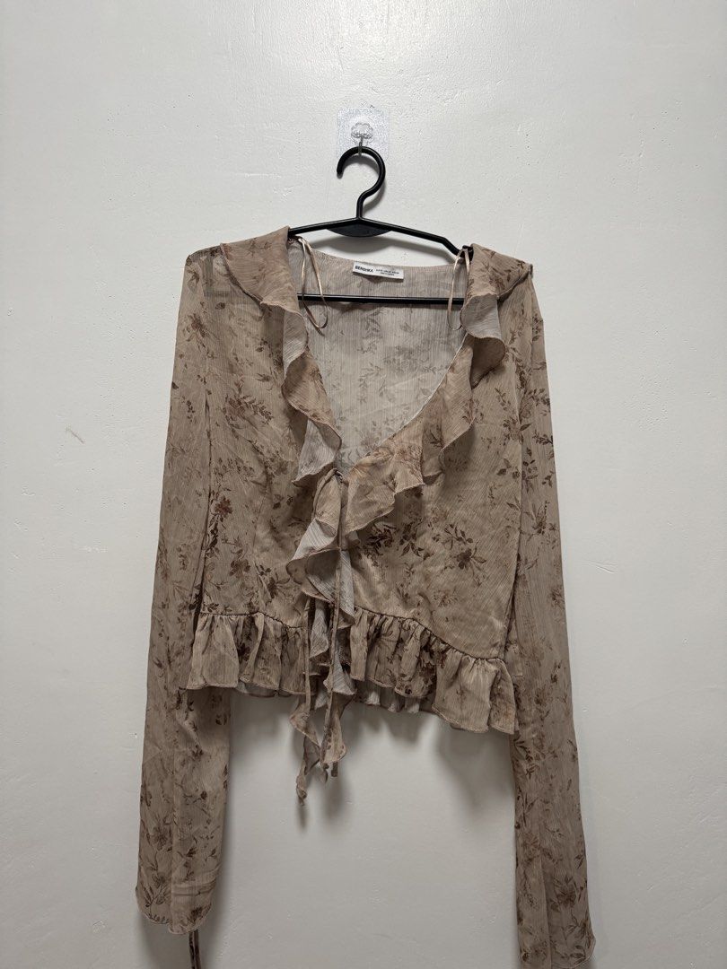 Bershka Floral Ruffle Blouse (Category: Blouses) located in Bocaue. Submitted by nyotcha (Listing ID 1432719034, Image 1). Description: - Bershka blouse - Floral print - Ruffle details - Long sleeves - Tie closure at waist - Size: XS Please see flaws. .