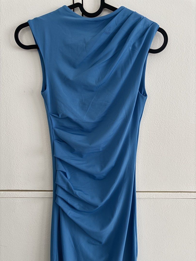 Blue Sleeveless Dress (Category: Dresses) located in Muntinlupa City. Submitted by aoki29 (Listing ID 1432630446, Image 1). Description: - Elegant blue midi dress - Sleeveless design - Features a draped neckline - Ruched detailing on the side - Fitted silhouette - Ideal for special occasions or a night out - Made from a smooth, stretchy fabric - used once only - pm for picture wearing the dress.