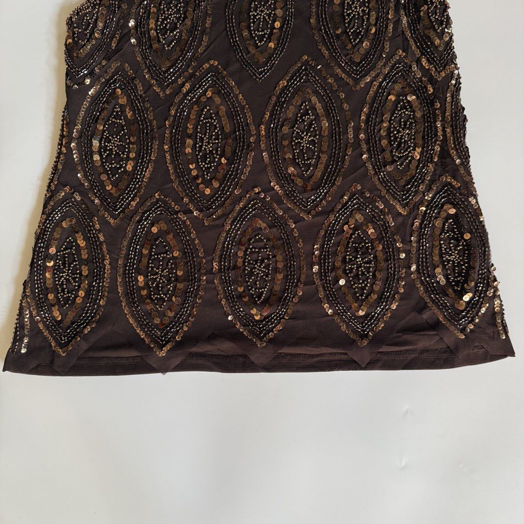 Brown Beaded Sleeveless Top (Category: Sleeveless) located in Iloilo. Submitted by notriaaa (Listing ID 1432764009, Image 3). Description: - Brown sleeveless top - Intricate bead and sequin detailing - Most Favorite Heavy Beaded Top ✨ -Size: fits Large -Bust: 38 -W: 32-33 Discoloration in some beads, see last photo ₱750.