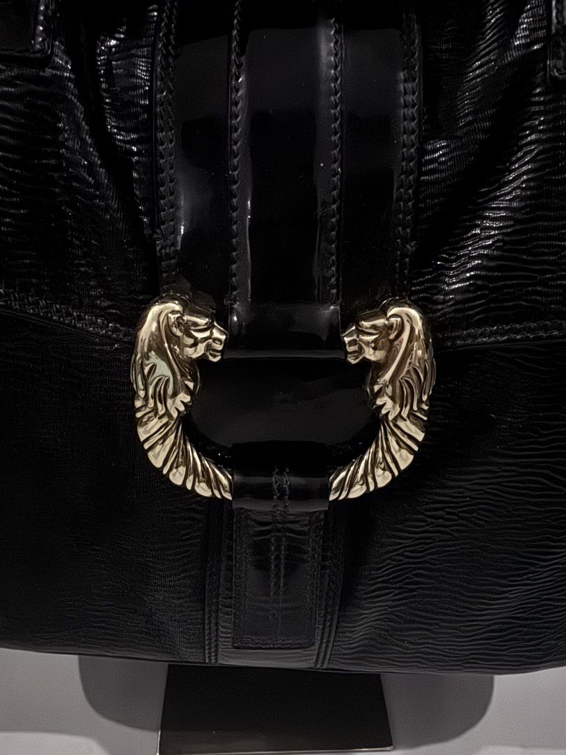 Bvlgari Black Leather Handbag (Category: Luxury Bags & Wallets) located in Dagupan City. Submitted by pardonmyfrench2025 (Listing ID 1432651392, Image 3). Description: - Authentic Bvlgari handbag - Black leather exterior - Unique lion head clasp - Top handle design - Interior lined with light green fabric - Includes zippered pocket - Textured exterior - Bvlgari logo on the back - Made in Italy.