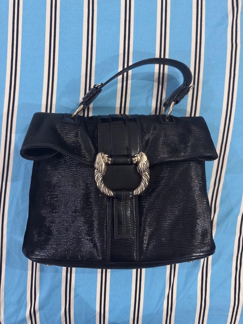 Bvlgari Black Leather Handbag (Category: Luxury Bags & Wallets) located in Dagupan City. Submitted by pardonmyfrench2025 (Listing ID 1432651392, Image 1). Description: - Authentic Bvlgari handbag - Black leather exterior - Unique lion head clasp - Top handle design - Interior lined with light green fabric - Includes zippered pocket - Textured exterior - Bvlgari logo on the back - Made in Italy.