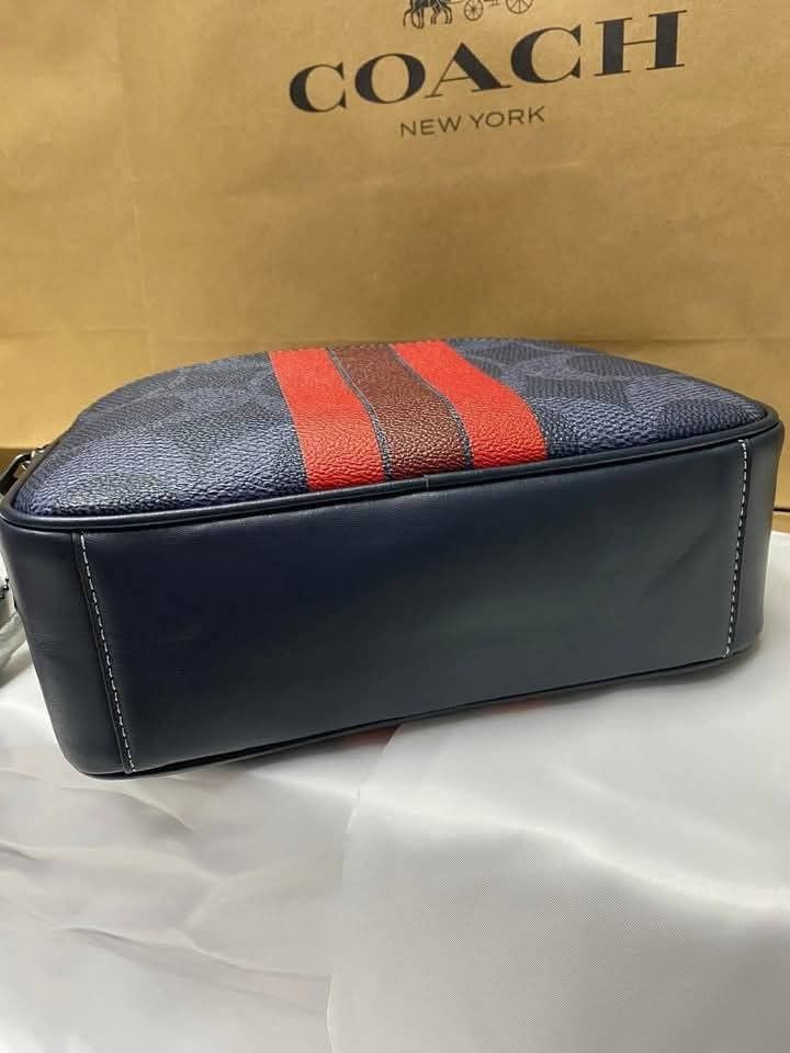 Coach Graham Body Bag (Category: Sling Bags) located in Rizal. Submitted by vanbdc24 (Listing ID 1432710260, Image 3). Description: - Brand new Coach crossbody bag - Navy blue and red stripe design - Zip closure - Adjustable red strap - Coach logo on the front - Spacious interior - Dimensions: 22x14cm - New with tags.