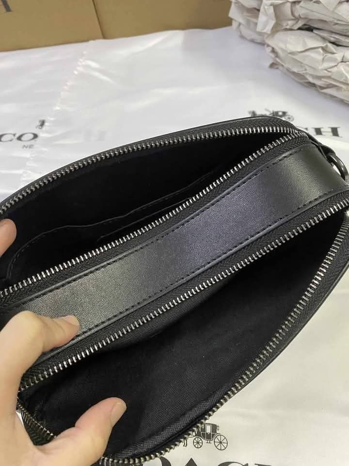 Coach Graham Crossbody Bag (Category: Sling Bags) located in Rizal. Submitted by vanbdc24 (Listing ID 1432709852, Image 3). Description: - Coach men's crossbody bag - Features a stylish black and grey monogram pattern - Secure top zip closure - Adjustable shoulder strap for a comfortable fit - Rectangular shape with Coach logo - Includes an interior pocket - Comes with a Coach dust bag - Dimensions: Approximately 22cm x 15cm.