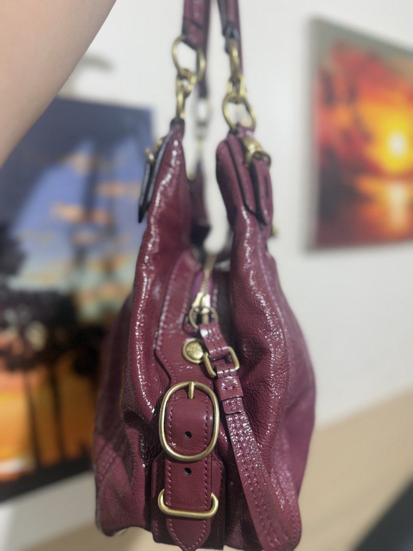Coach Maggie Mia Hobo Bag (Category: Shoulder Bags) located in Quezon City. Submitted by vianca13 (Listing ID 1432689183, Image 3). Description: - Authentic Coach Maggie Mia hobo bag - Stunning purple color with gold-tone hardware - Classic hobo shape with pleated design - Spacious interior with multiple compartments - Secure zip closure - Includes a Coach hangtag - Comfortable shoulder strap - Features a glossy exterior finish - Super Minimal si