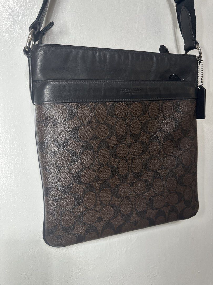 Coach Signature Crossbody Bag (Category: Luxury Bags & Wallets) located in Batangas. Submitted by jim2621 (Listing ID 1432637613, Image 2). Description: - Coach crossbody bag - Signature pattern - Black leather top - Adjustable strap - Zip closure - Front pocket - Coach logo visible - Designed for everyday use.