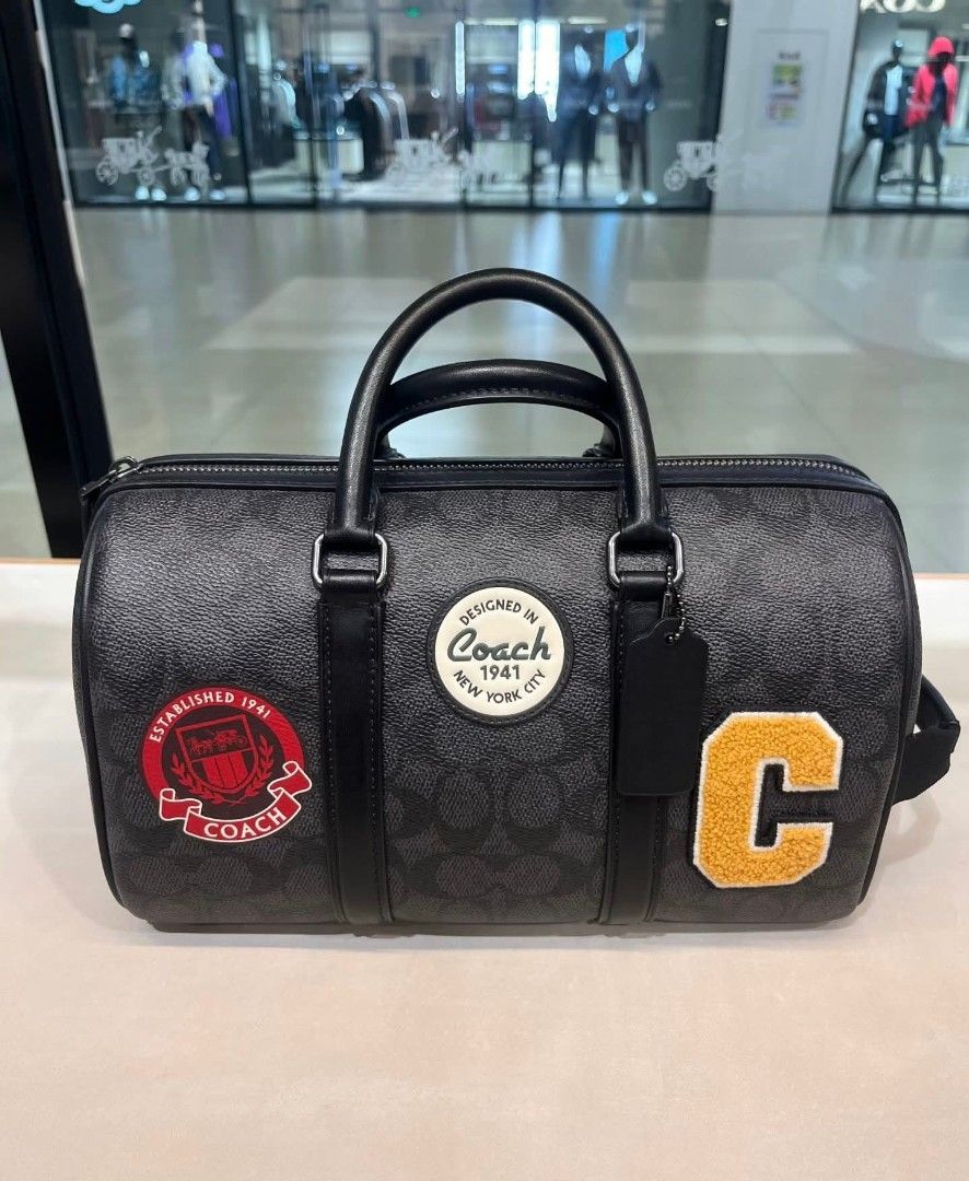 Coach Venturer Duffle Bag (Category: Luxury Bags & Wallets) located in Rizal. Submitted by vanbdc24 (Listing ID 1432706739, Image 3). Description: - Coach duffle bag - Signature monogram pattern - Features various patches - Top handle - Zip closure - Available in different sizes and colors - Classic design - Includes a detachable tag - Ideal for travel or everyday use.
