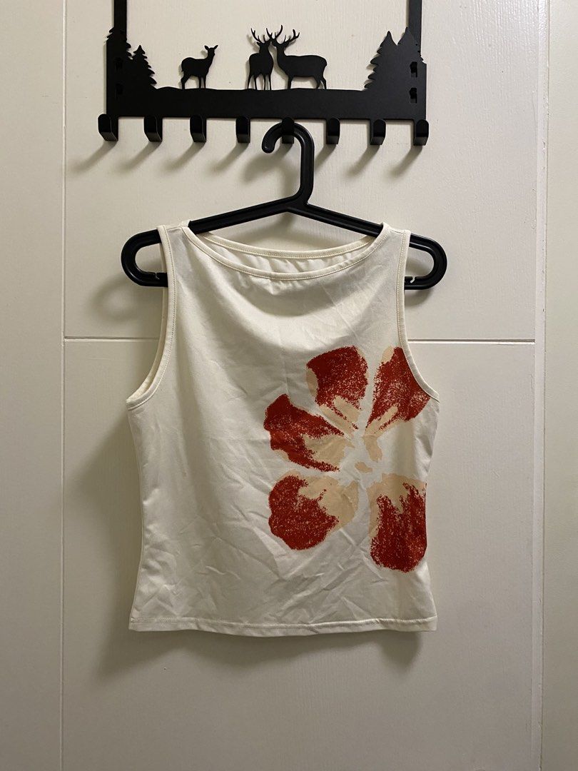 Y2K Cream Tank with Flower Print (Category: Sleeveless) located in Quezon City. Submitted by abby11.12a (Listing ID 1432728672, Image 1). Description: - Cream-colored tank top - Eye-catching red floral print - Boat neckline - Bought here and reselling for the same price. Decluttering..