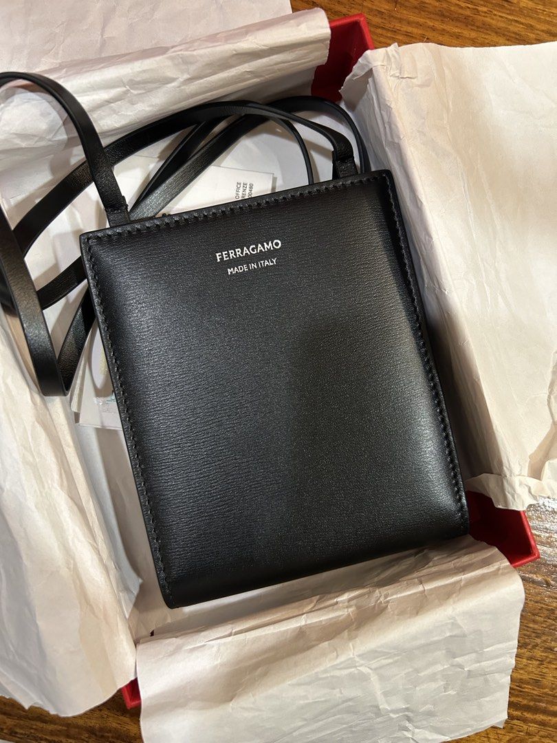 Ferragamo Calf Leather Card Holder (Category: Luxury Bags & Wallets) located in Paranaque City. Submitted by daftspect (Listing ID 1432736731, Image 2). Description: Ferragamo Black Calfskin Cardholder with Sling • RFS: Funds, not my style • Condition: Brand new in packaging, besides to take pictures • Can request further pictures • Price negotiable MOD: Meet-up, Lalamove MOP: GCash, bank transfer .