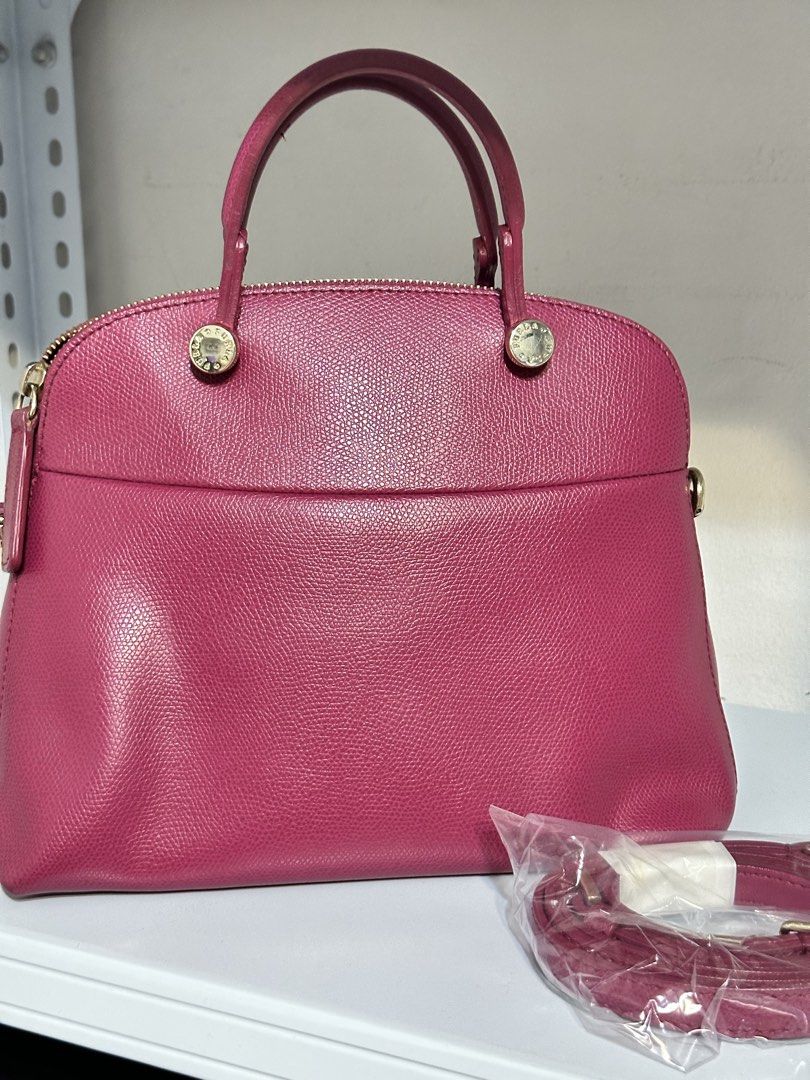 Furla Piper Small Handbag with Shoulder Strap (Category: Luxury Bags & Wallets) located in Quezon City. Submitted by whengaloolu (Listing ID 1432686705, Image 2). Description: - Authentic Furla dome handbag - Vibrant pink color - Top handle and detachable shoulder strap - Secure zip closure - Elegant gold-tone hardware - Interior pocket - Includes original packaging for shoulder strap - Classic and stylish design.