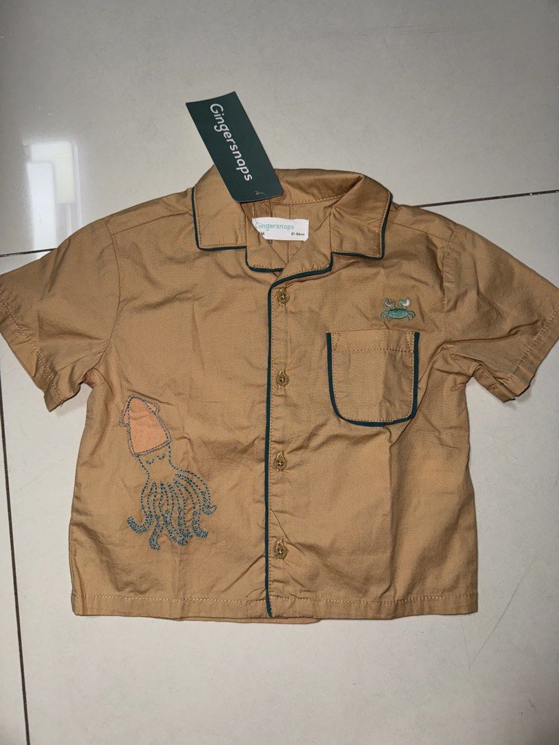 Gingersnaps Embroidered Shirt 18M (Category: Babies & Kids Fashion) located in Manila. Submitted by declutter_with_mrs (Listing ID 1432749539, Image 1). Description: - Gingersnaps short-sleeved shirt - Color: Tan - Design: Embroidered octopus and crab - Pocket with green trim - Green trim on collar and sleeves - Button-down closure - Size: 18M RFS: decluttering MOP: gcash MOD: grab/lalamove PICKUP LOC: BGC, Taguig SF shoulder by buyer STRICTLY PA