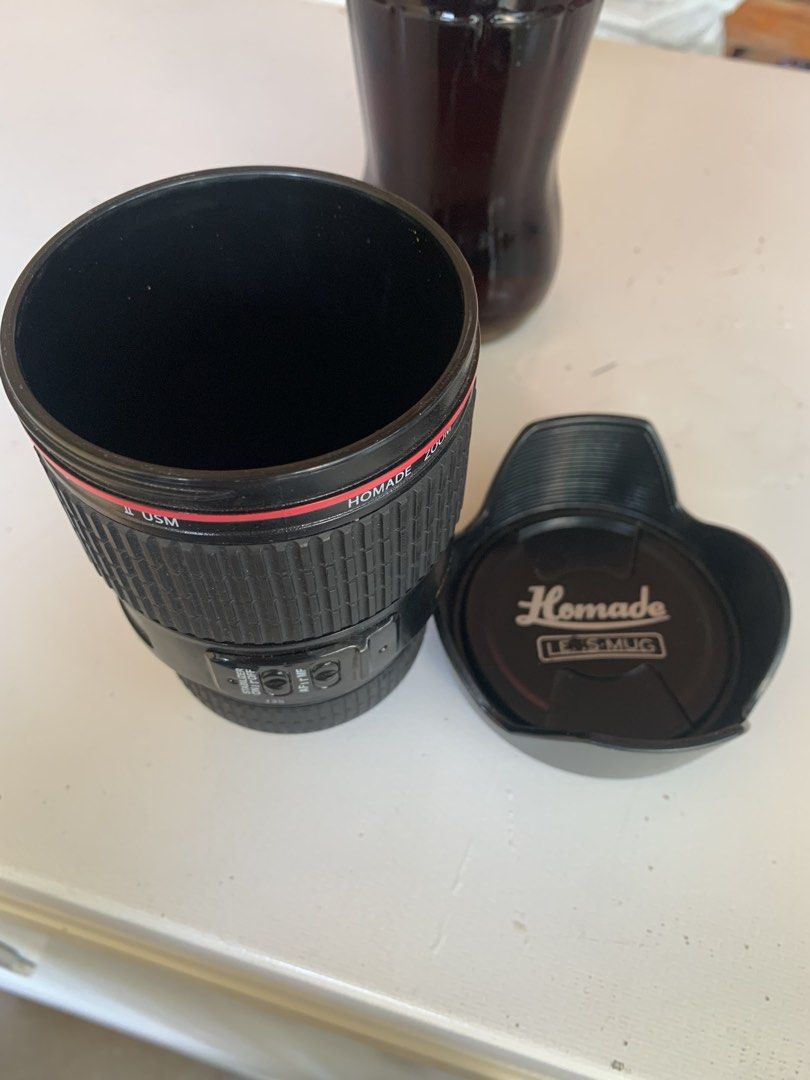LENS MUG WITH BISCUITS HOLDER, NOVELTY PLASTIC MUG (Category: Coffee & Tea Tableware) located in Calasiao. Submitted by beardmodefinds0707 (Listing ID 1432668317, Image 2). Description: LENS MUG WITH BISCUITS HOLDER, NOVELTY PLASTIC MUG ESF 28-135 mm MODEL 3.5” x 6” EXCELLENT CONDITION ISSUE N IN LENS- MUG, DEADSTOCK CONDITION 9.5/10 COLOR RATE .