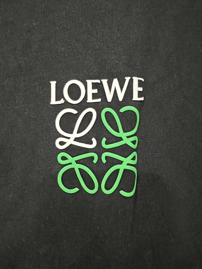 Loewe Black T-shirt (Category: Tshirts & Polo Shirts ) located in Meycauayan. Submitted by 3fold (Listing ID 1432699572, Image 3). Description: - Black Loewe t-shirt - Features the Loewe logo on the front - Additional logo detail at the back of the neck - Crew neck design - Short sleeves - Relaxed fit - Includes a small tag at the bottom.