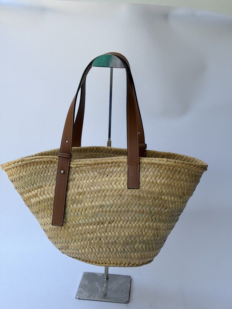 Loewe Raffia Basket Tote Bag Natural Tan AUTHENTIC (Category: Luxury Bags & Wallets) located in Rizal. Submitted by lovelyscloset (Listing ID 1432701096, Image 3). Description: - Authentic Loewe basket bag. - Woven straw body. - Brown leather handles. - Features Loewe logo patch. - Secure leather straps and metal hardware. - Spacious interior. - Ideal for daily use..