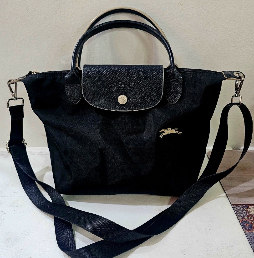 Longchamp Black Handbag with Shoulder Strap MINI (Category: Luxury Bags & Wallets) located in Davao. Submitted by sachigo (Listing ID 1432646297, Image 1). Description: - Authentic Longchamp handbag - Classic black color - Gold-colored logo - Flap closure - Detachable shoulder strap - Secure zipper closure - Interior tag with care instructions - Metal zipper pull with Longchamp logo - Made in China shoulder strap customized by the owner .