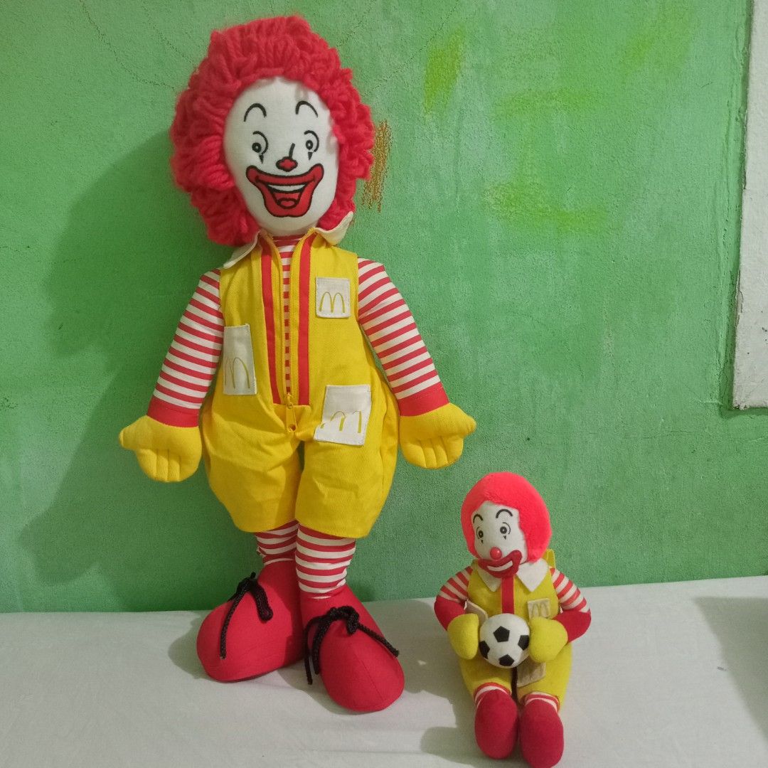 McDonald's Ronald McDonald Plush Doll (Category: Plushies & Soft Toys) located in Manila. Submitted by feg39 (Listing ID 1432686954, Image 1). Description: - Vintage Ronald McDonald plush doll - Large doll features: - Red wig - Yellow jumpsuit with McDonald's logo - Red and white striped sleeves and legs - Smiling face - Red shoes - Includes a smaller Ronald McDonald doll holding a soccer ball - Tag with Japanese text *** 16inch Grimace 2002 is a