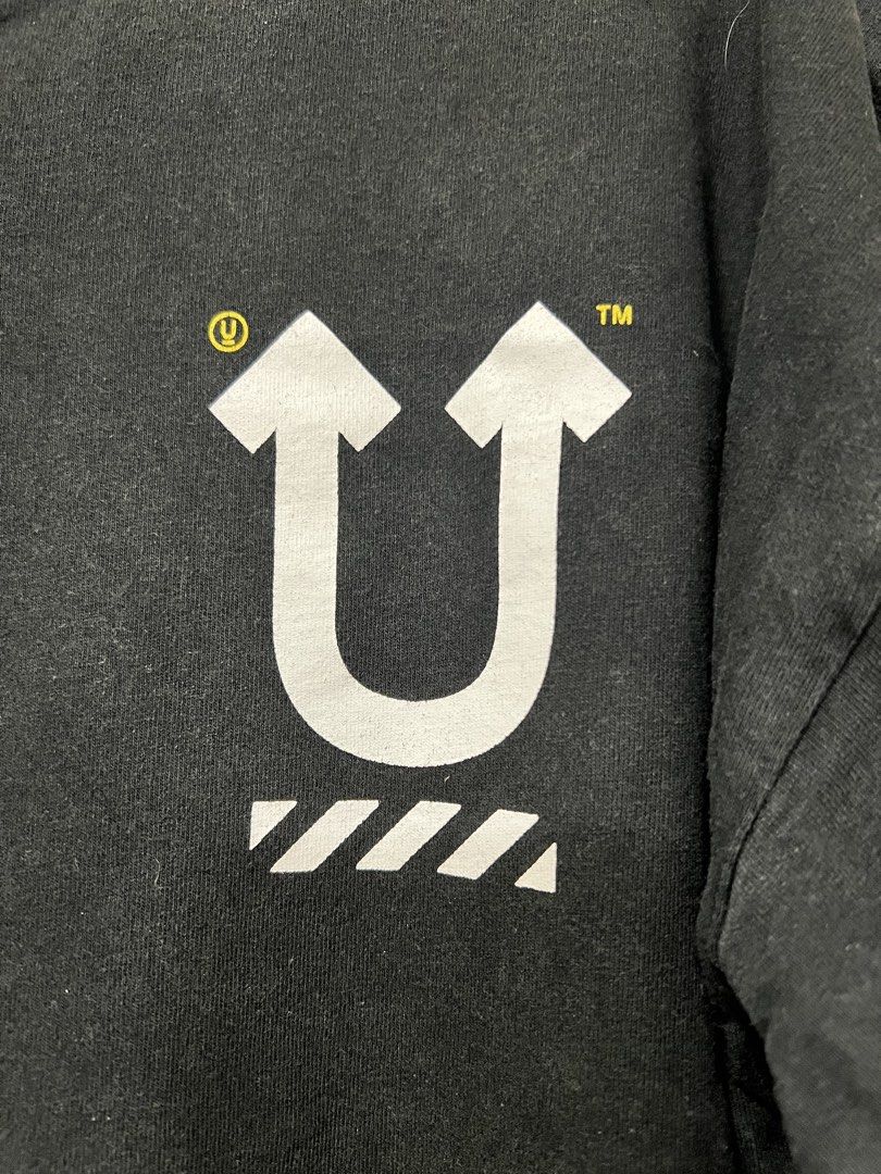 Off-White Undercover Skeleton Tee (Category: Tshirts & Polo Shirts ) located in Meycauayan. Submitted by 3fold (Listing ID 1432699883, Image 2). Description: - Black Off-White Undercover T-shirt - Size: M - Features: - Front: White "U" logo with arrows - Back: Skeleton graphic with "UNDERCOVEROFFWHITE LOVERS" text - Made in Portugal - Material: 100% cotton.