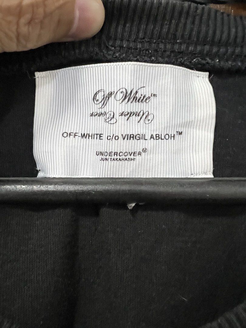 Off-White Undercover Skeleton Tee (Category: Tshirts & Polo Shirts ) located in Meycauayan. Submitted by 3fold (Listing ID 1432699883, Image 3). Description: - Black Off-White Undercover T-shirt - Size: M - Features: - Front: White "U" logo with arrows - Back: Skeleton graphic with "UNDERCOVEROFFWHITE LOVERS" text - Made in Portugal - Material: 100% cotton.