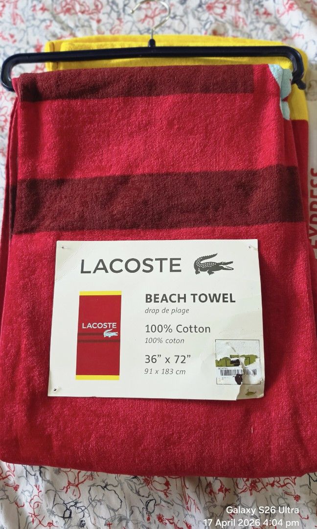Original Lacoste Beach Towel 36" x 72" (Category: Bedding & Towels) located in Carmona. Submitted by Asimplehappinesstore (Listing ID 1432677757, Image 2). Description: - Brand new Lacoste beach towel - Made of 100% cotton - Features the Lacoste logo - Eye-catching red and yellow design - Generous size: 36" x 72" (91 x 183 cm) - Ideal for beach and pool use - Never been used.